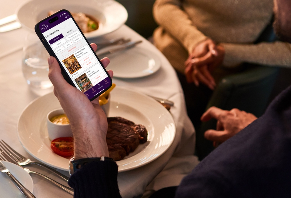 Evolv Rewards - Man dining and using app to earn points